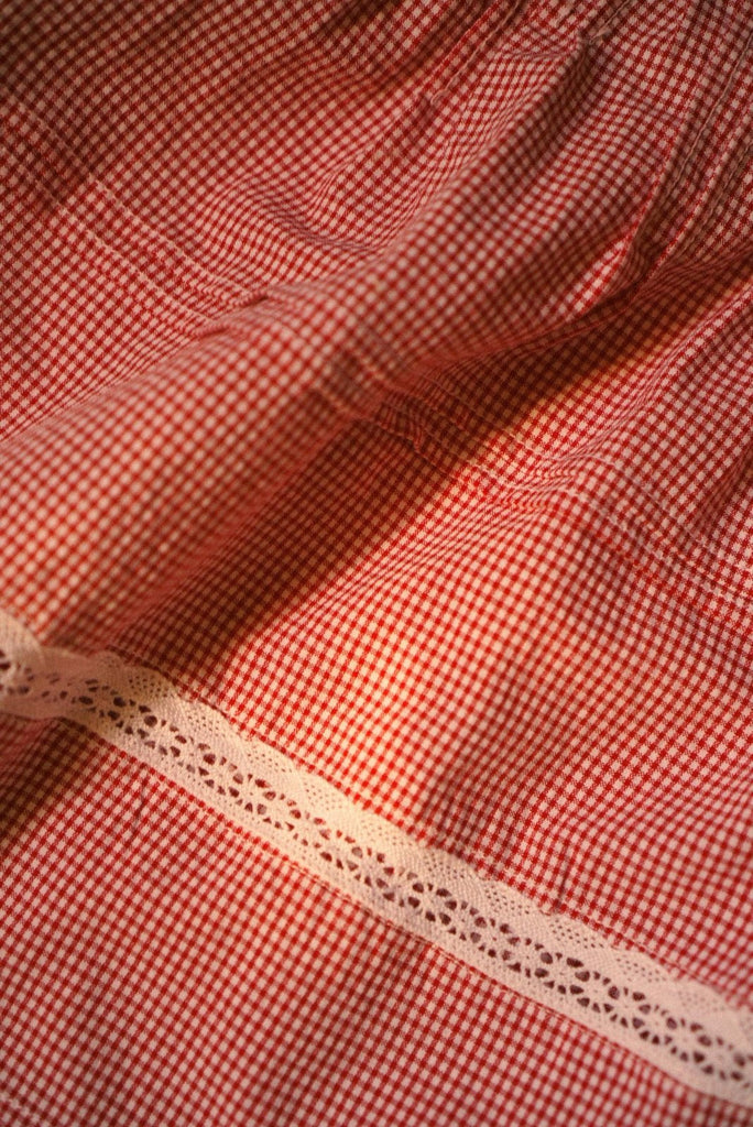 Red gingham fabric with a delicate lace insertion